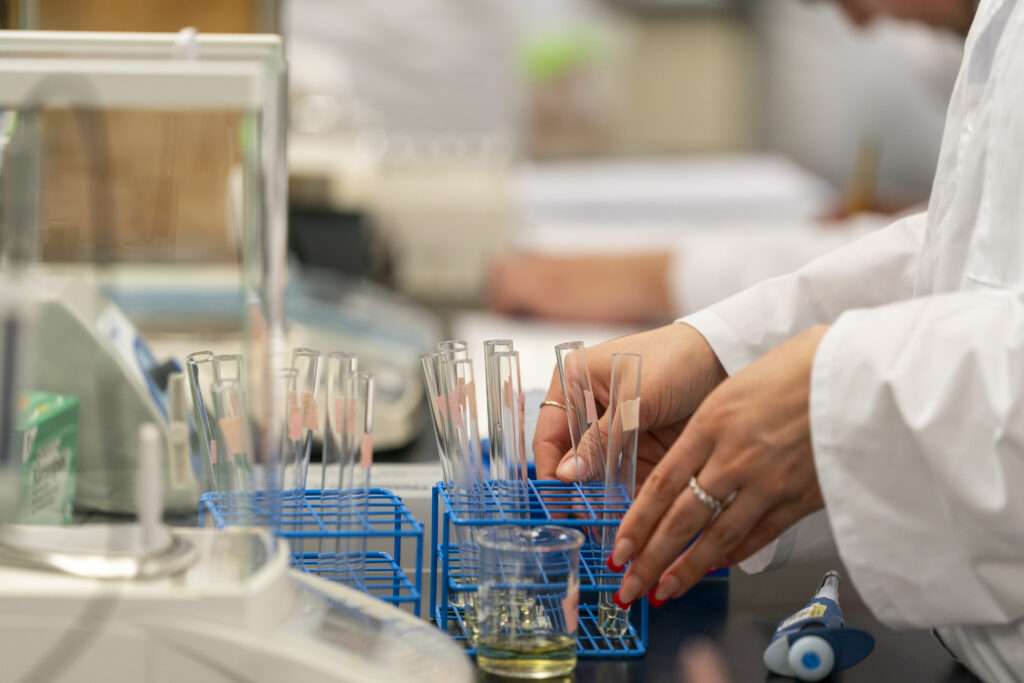 hands arranging beakers in a lab