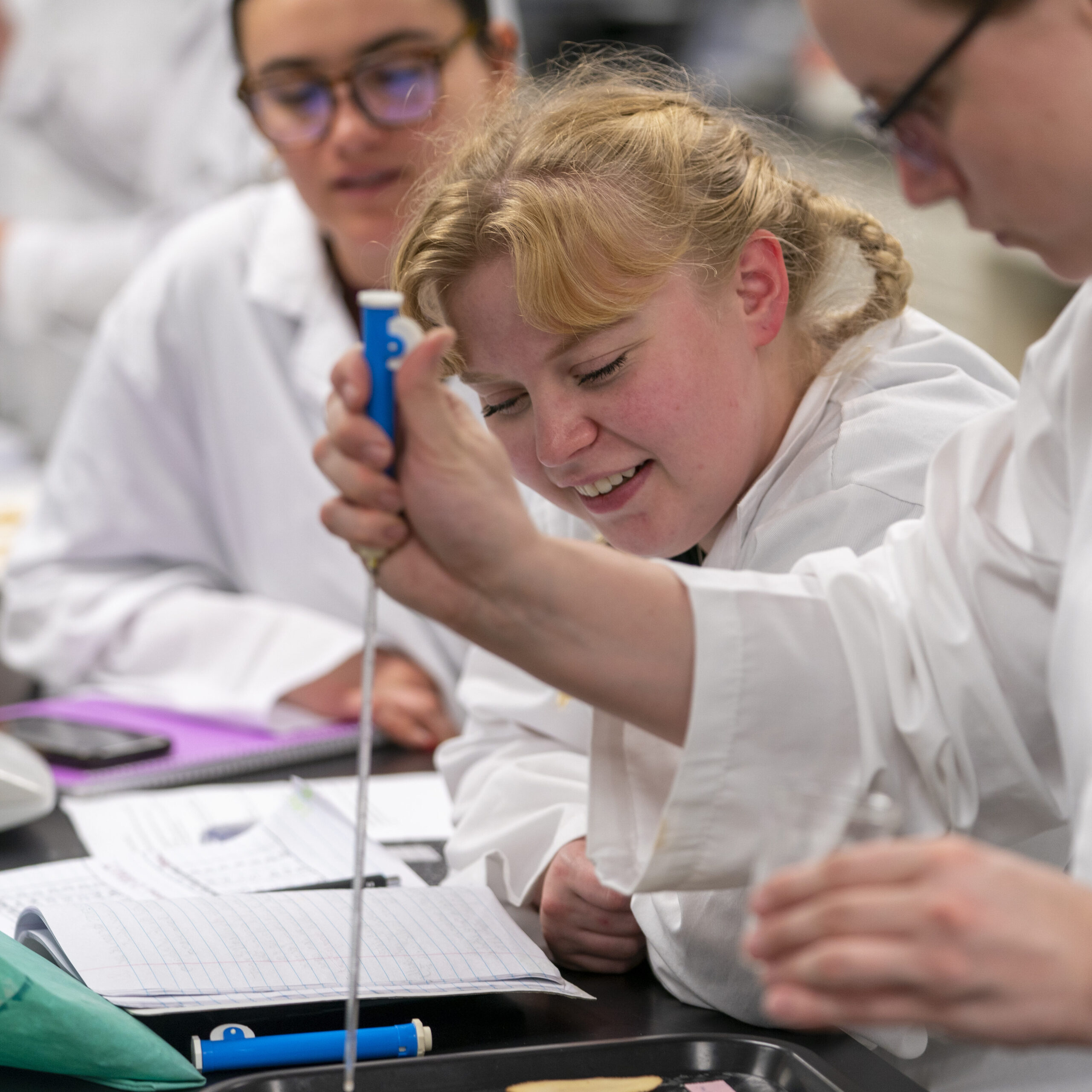 Students in lab with notebooks on the table