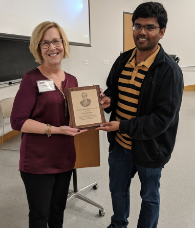 two people posing with an award
