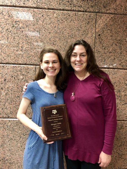 two people posing with an award
