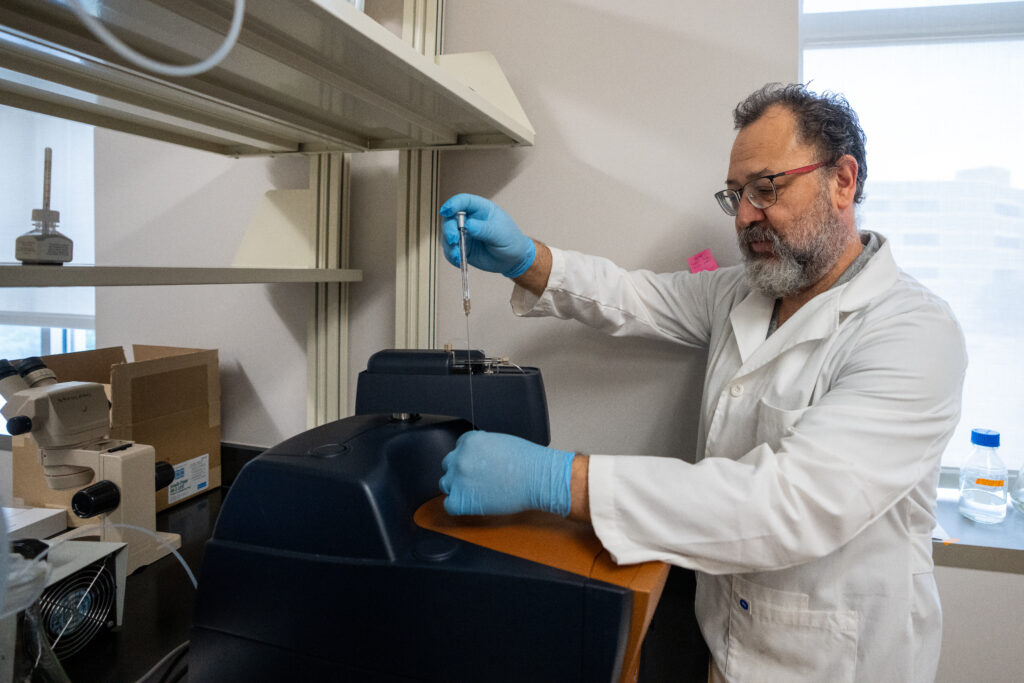 Researcher examining a sample in a lab